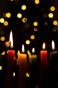 Close-up of lit candles in temple