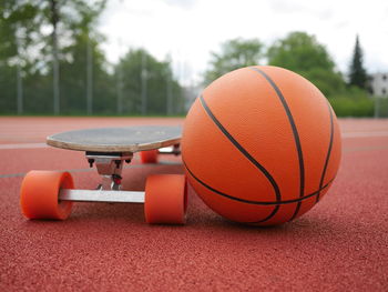 Close-up of basketball and skateboard at park