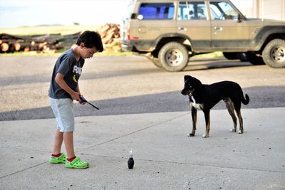 Rear view of man with dogs on street