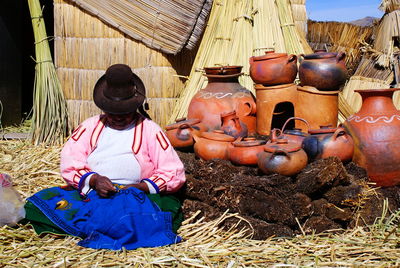 Midsection of woman sitting outdoors