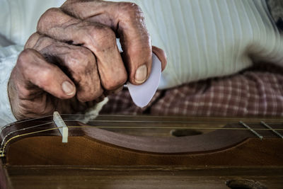 Close-up of man playing instrument
