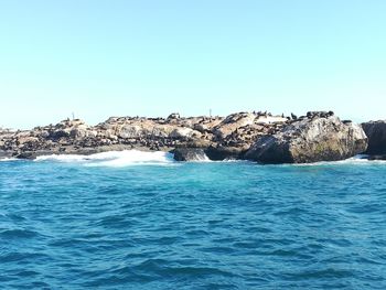 Scenic view of sea against clear blue sky