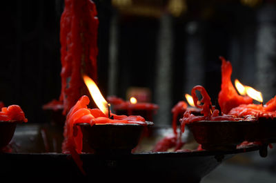 Close-up of burning candles in temple