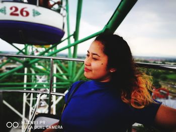 Portrait of boy looking at amusement park