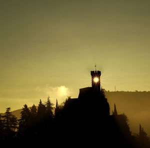 Silhouette built structure against sky during sunset