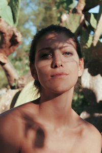 Close-up portrait of young woman at park