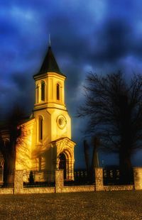 Low angle view of bell tower against cloudy sky