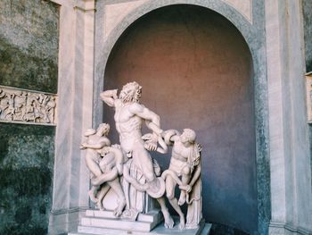 Statue against historic building