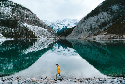 Scenic view of snowcapped mountains by lake during winter