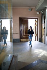 Rear view of woman walking in corridor