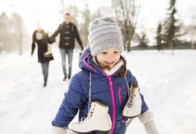 Little girl going ice skating with her parents