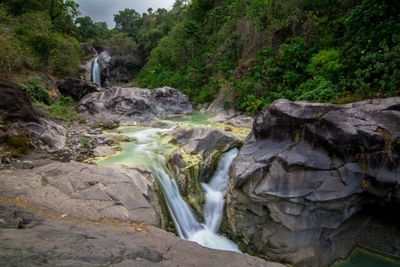 Scenic view of river flowing through rocks