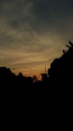 Silhouette trees against sky during sunset