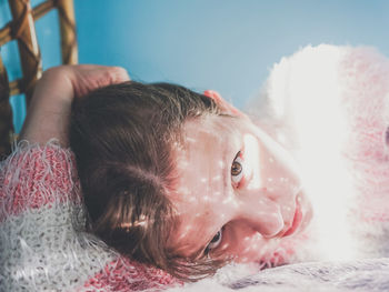 Portrait of woman lying on bed