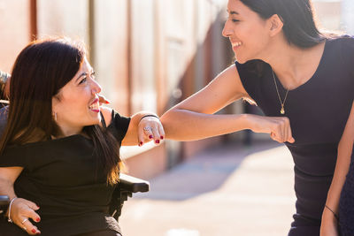 Side view of young woman exercising in gym