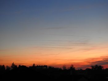 Silhouette trees against sky during sunset