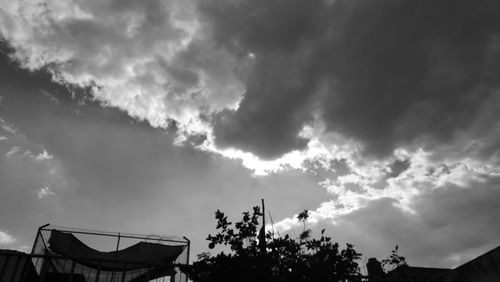 Low angle view of silhouette trees against sky