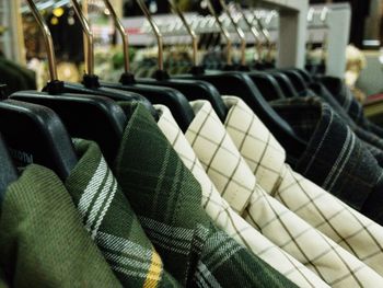 Close-up of clothes hanging on rack in store