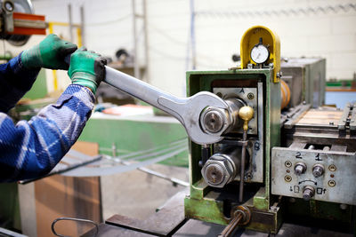 Cropped image of manual worker working in factory
