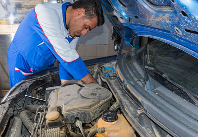 Mechanic repairing car at auto repair shop