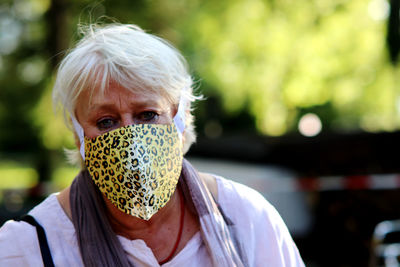 Portrait of woman wearing mask outdoors