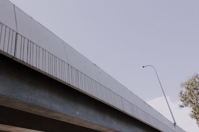 Low angle view of bridge against sky in city