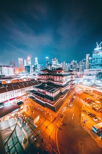 High angle view of illuminated buildings in city at night