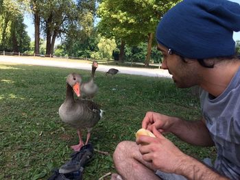 Two birds perching on hand