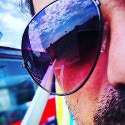 Reflection of man in sunglasses