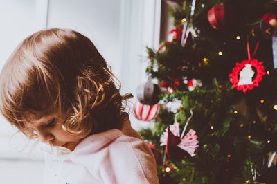 Girl with christmas tree at home