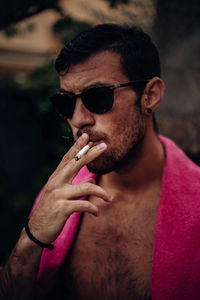Guy with sunglasses and a cigarette in his mouth. person