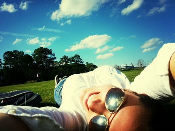 Person relaxing on grassy field