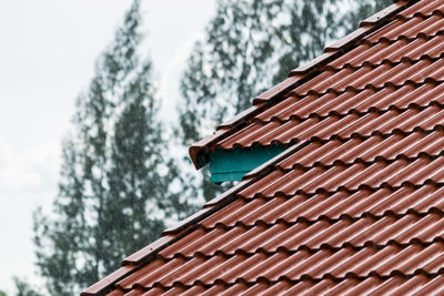 Low angle view of building roof against sky