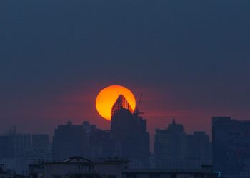 Silhouette of buildings against sky during sunset