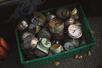 High angle view of alarm clocks in container
