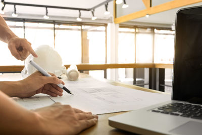 Midsection of woman working on table