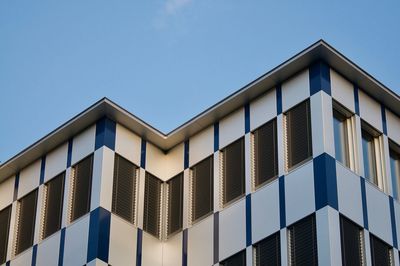 Low angle view of modern building against clear blue sky