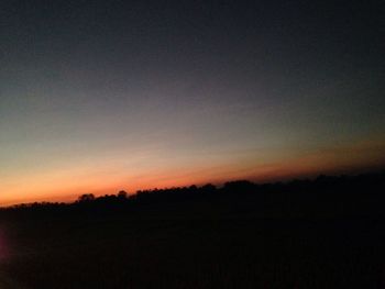 Scenic view of silhouette landscape against sky at sunset