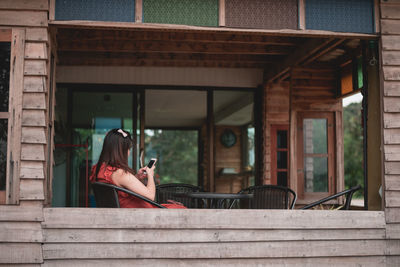 Woman sitting outside building