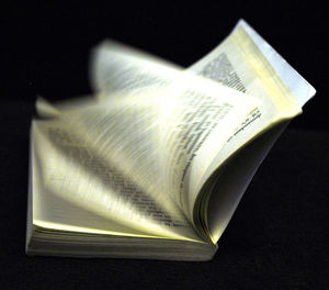 Close-up of open book against black background