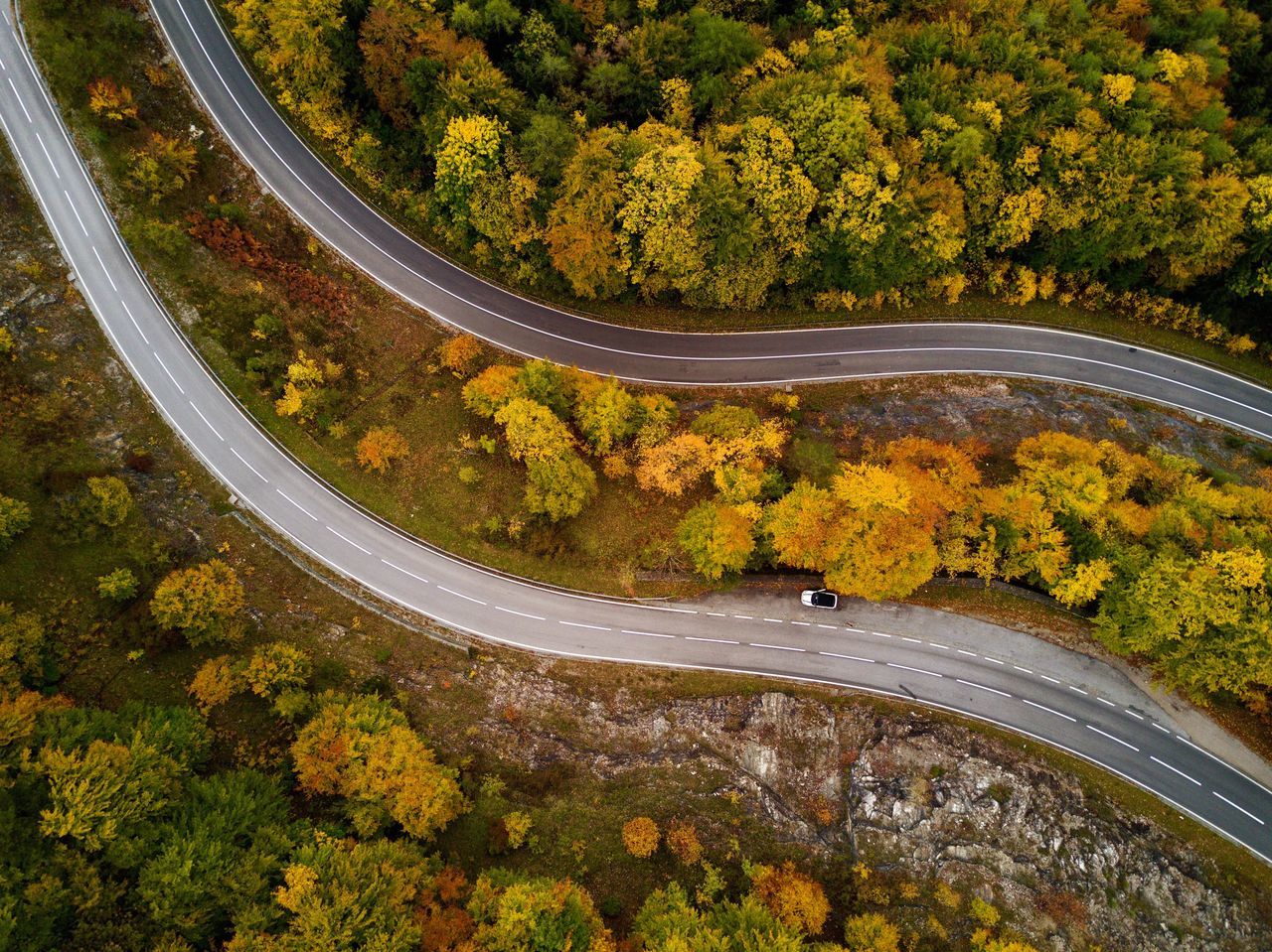 tree, autumn, change, high angle view, road, scenics, transportation, nature, winding road, outdoors, curve, leaf, aerial view, forest, beauty in nature, multi colored, day, no people, dividing line, tranquility, landscape