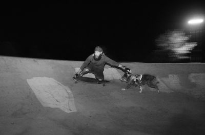 Man riding motorcycle on street at night