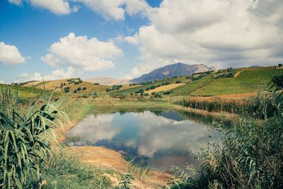 Panoramic view of lake against cloudy sky