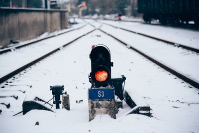 Text on snow covered railroad tracks