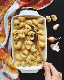 Cropped image of hand serving pasta
