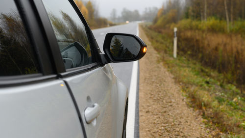 Close-up of car on road