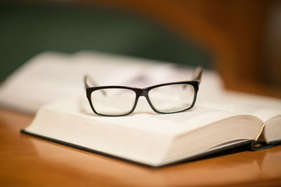 Close-up of eyeglasses on book