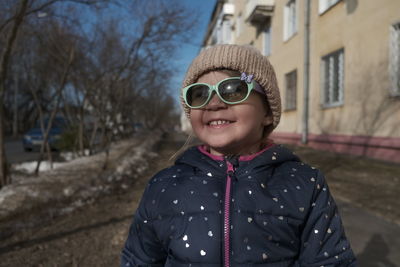 Portrait of smiling boy standing outdoors