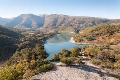 Scenic view of lake and mountains against sky