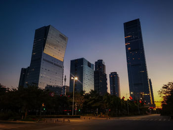 Low angle view of illuminated buildings against sky at night